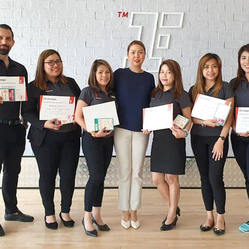 Fitness First employees holding their certificates